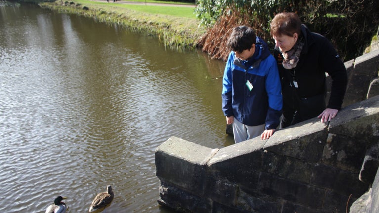 Volunteers looking for fish at Biddulph Grange Garden in Staffordshire